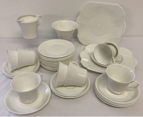 A quantity of Shelley tea ware in plain white glaze, some pieces with green backstamp. Comprising: 12 cake plates, 12 saucers