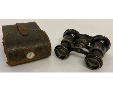 A small pair of French antique cyclist binoculars, marked "La Bicycliste", in a leather case. Leather carry case is set with 