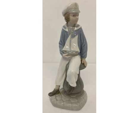 A Lladro ceramic retired figurine #4810 Sailor "Boy with Yacht", modelled by Salvador Furio. Unboxed. Approx. 23cm tall.