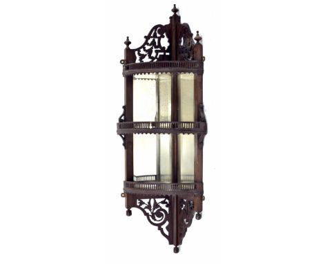 Aesthetic mahogany corner shelved bracket, with pierced raised back surmounted by three turned finials over three pierced gal
