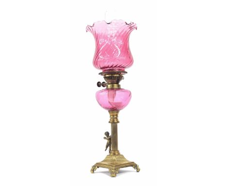 Victorian brass and cranberry glass oil lamp,&nbsp;with fluted flared shade and glass font raised on a pillar support with wi