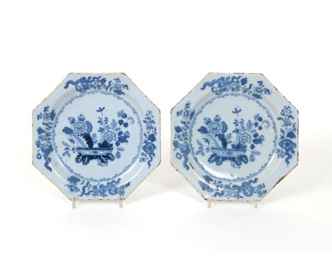 A pair of delftware octagonal plates, mid 18th century, painted in blue with arrangements of Oriental flowers issuing from lo