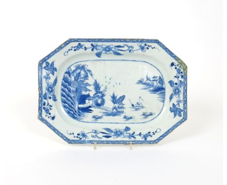 A large Bow blue and white octagonal dish, c.1752-55, painted with a figure in a sampan beside a bridge linking pagodas and s