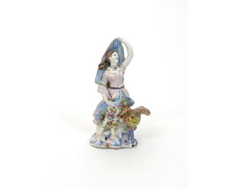 A Bow figure emblematic of Air, c.1760, modelled as a maiden holding her billowing cloak aloft and standing before a rocky ba