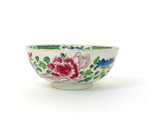 A large Bow punch bowl, c.1754, decorated in the famille rose palette with large pink peony blooms and blue chrysanthemum bef