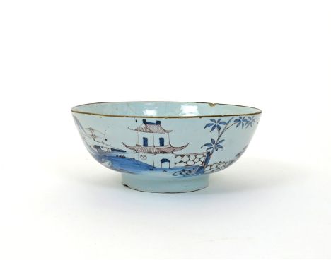 A large Bristol delftware punch bowl, c.1760, decorated to the exterior in blue and manganese with pagodas on an island amids