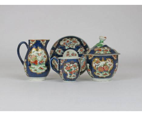 A combined Worcester part tea service, c.1775, enamelled with panels of flowers and corn stooks in the Kakiemon palette withi