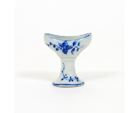 An English porcelain blue and white eyebath, c.1775-80, probably Worcester or Caughley, painted with simple flower sprigs to 