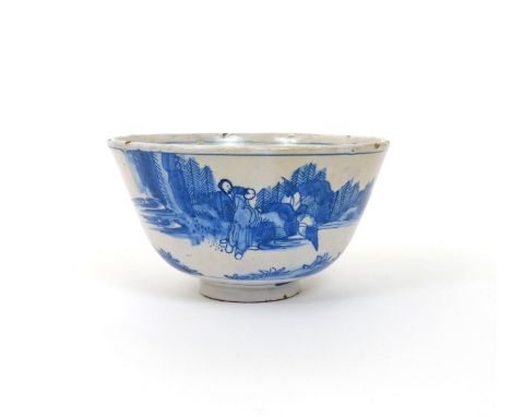 An early English delftware bowl, c.1670, possibly London, the exterior painted in blue with three Chinese figures in a contin