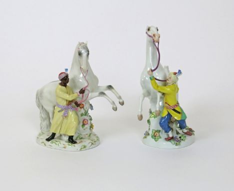 A matched pair of Meissen figures of Arab stallions and their grooms, 19th and 20th centuries, after the models by J J Kändle