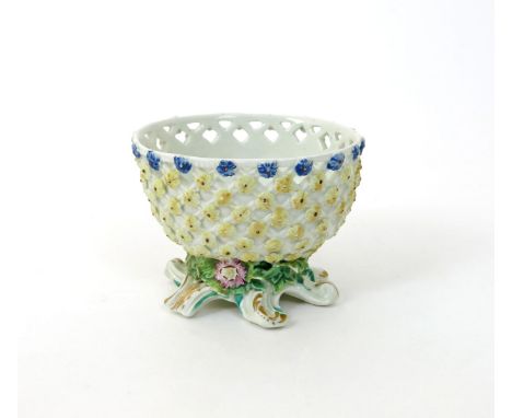 A rare Derby basket or sweetmeat stand, c.1760-70, the oval form applied with small yellow flowerheads beneath a line of blue