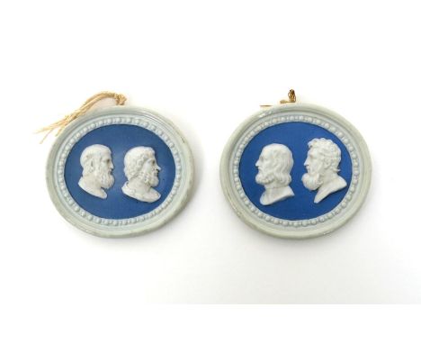 A rare pair of Doccia oval double portrait plaques, mid 18th century, each applied with two profile busts of Ancient Greeks, 