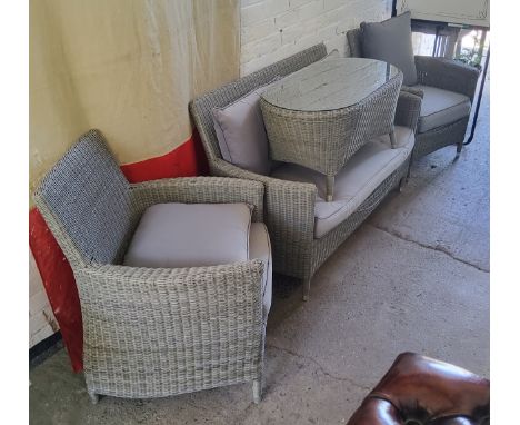 A modern woven wicker effect conservatory suite comprising of a two seater sofa, two armchairs and a coffee table 