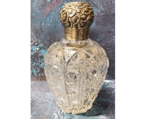 A large Victorian clear cut glass and silver scent bottle, the screw-off cover embossed with stylised flowerheads, 14cm high,