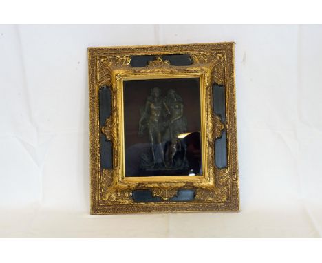 A bronze panel depicting a nude male, female and child, mounted in an ebonised and gilt frame.  14¼ by 16¼ins.  Est £80-120