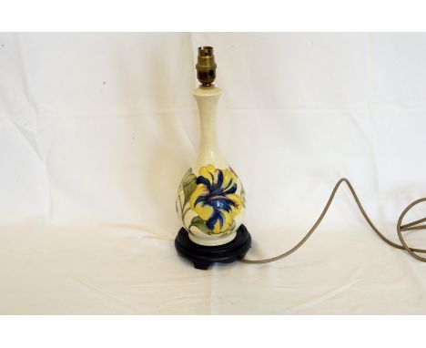 A Moorcroft pottery reading lamp, the white ground with floral decoration, stamp to base Moorcroft made in England and on a t