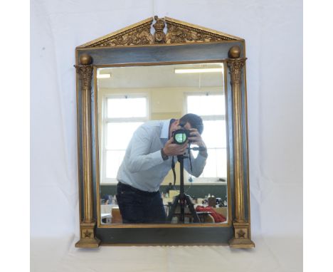 A 19th century wall mirror, the triangular broken pediment with central masonic crest, the mirror plate flanked by two reeded