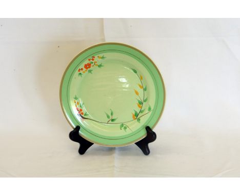 A Clarice Cliff Newport Pottery plate, the light green ground with leaf and flower head decoration surrounded by a darker gre