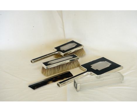 An Edward VIII Art Deco silver and tortoise shell dressing table set comprising hand mirror, hair brush, clothes brush, comb 