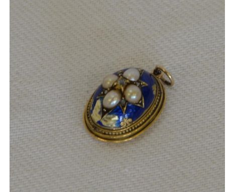 A gold coloured metal oval pendant with blue enamel decoration set with four pearls flanked by diamond chips (enamel af).  Es
