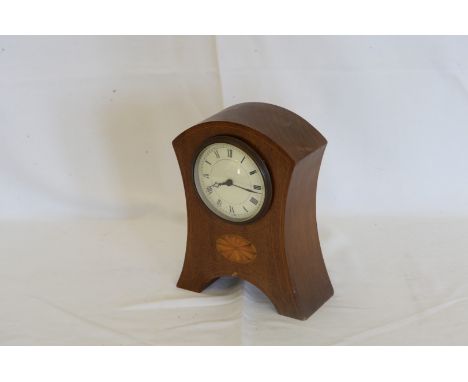 An Edwardian walnut, boxwood and marquetry inlaid mantle clock, the dial with roman numerals above a fan marquetry inlaid low