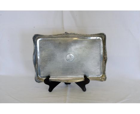 A George V silver dressing table tray with wavy border and central field with engine turned decoration, central circular cart