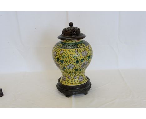 A Chinese Kangxi type porcelain vase with pierced floral decorated cover, the body with yellow ground, floral decoration and 