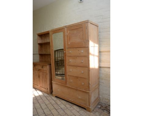 A Victorian pine wardrobe with bevelled mirror door, the right-hand side with a panelled cupboard door, four drawers below an