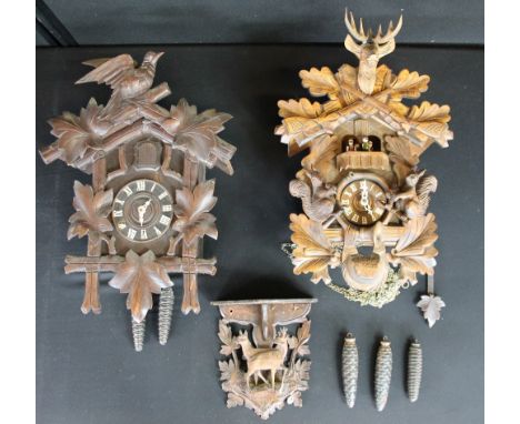 CUCKOO CLOCKS - two vintage wooden cuckoo clocks and a black forest carved shelf. One clock has a modern quartz movement. 