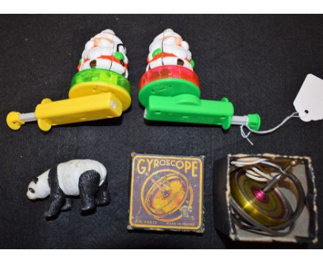 Toys - A boxed M W Paris gyroscope; a near pair of German/Chinese spinning Santa Claus/Snowman light ups;  a panda (4)