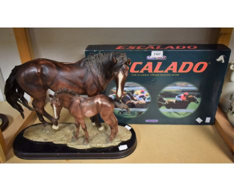 A large resin group, horse and foal, oval base, 35cm high, 44cm wide; a Chad Valley Escalado horse racing game (2)