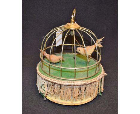 A musical automaton bird cage, swinging action, steel metal cage, fabric fringe 