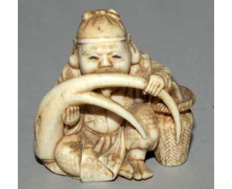 A GOOD SIGNED JAPANESE MEIJI PERIOD CARVED IVORY NETSUKE OF DAIKOKU, seated and attempting to eat a giant root plant, the det