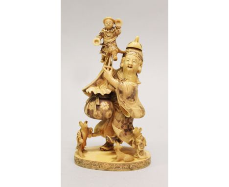 A FINE QUALITY SIGNED JAPANESE MEIJI PERIOD IVORY OKIMONO OF A PUPPETEER, holding aloft a puppet of a boy bearing cymbals, th