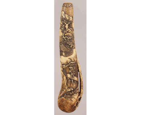 A GOOD QUALITY JAPANESE EDO PERIOD CARVED STAG ANTLER KISERUTSU, the pipe case well carved in shallow relief with a traveller
