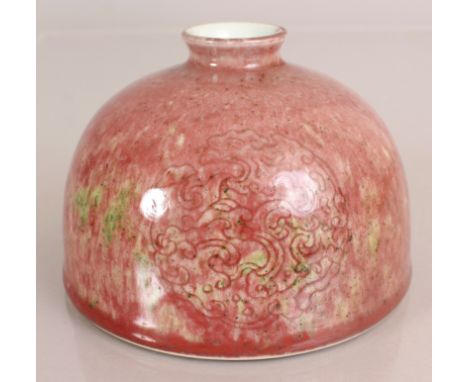 A CHINESE PEACH BLOOM GLAZED PORCELAIN WATER POT, the streaked glaze with green inclusions, the sides decorated underneath th