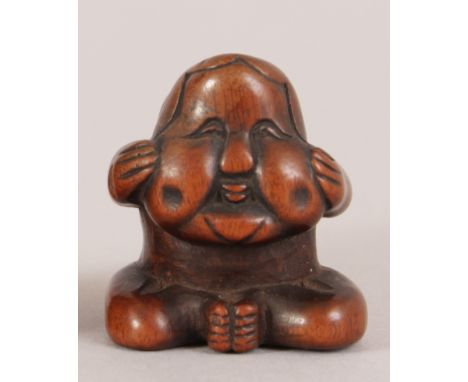 A JAPANESE MEIJI PERIOD CARVED BOXWOOD NETSUKE OF A SEATED MONKEY WEARING AN OKAME NOH MASK, 1.2in high.