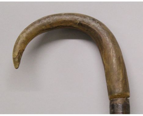 ANOTHER 19TH CENTURY RHINO HORN HANDLED WOOD WALKING STICK, the yellowish-amber curved rhinoceros horn with a tight grain, 34