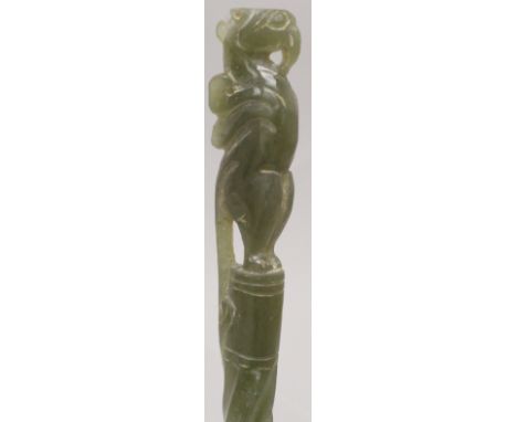 A CHINESE DARK GREEN JADE-LIKE HAIR PIN ORNAMENT, with dragon handle and spiral stem, 10.2in long.