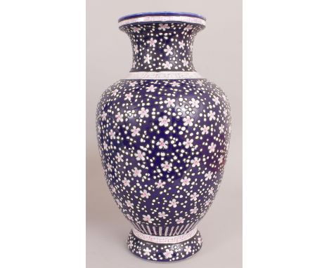 A LARGE CHINESE BLUE GROUND FAMILLE ROSE PORCELAIN VASE, decorated in pink and white enamels with scattered flowerheads betwe