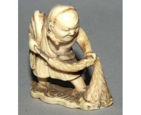 AN UNUSUAL JAPANESE EDO PERIOD CARVED IVORY NETSUKE OF A FISHERMAN, the man with larger than average features and wading in w