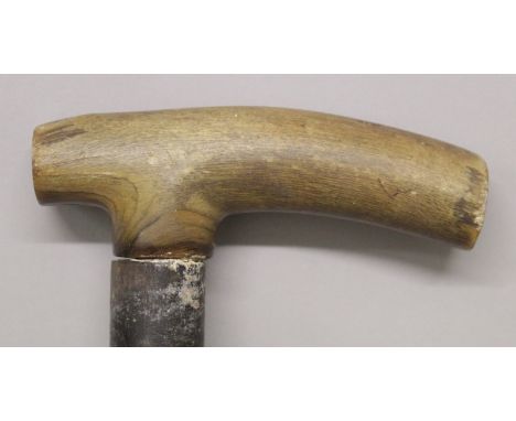 A 19TH CENTURY RHINO HORN HANDLED WOOD WALKING STICK, the yellowish-amber rhinoceros horn with a tight grain, 33.25in long, t