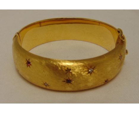 18ct yellow gold bangle set with diamonds and rubies, approx total weight 46.2g