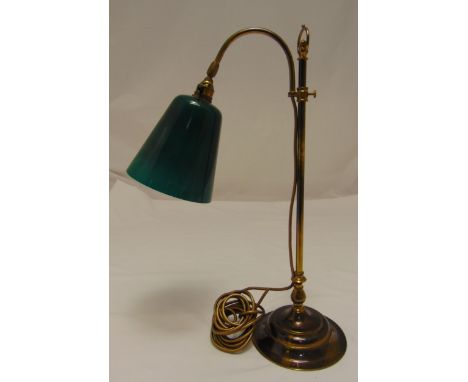 An early 20th century desk lamp with adjustable green glass shade on raised circular base, 56cm (h)