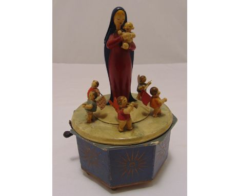A German painted wooden musical carousel of octagonal form surmounted by Mary holding the baby Jesus, surrounded by six angel