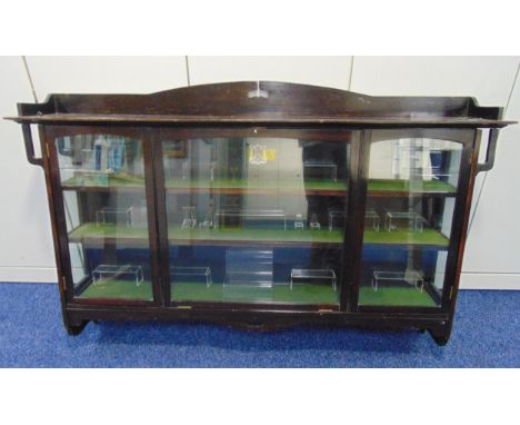 An early 20th century rectangular and glazed mahogany Goss cabinet with applied ceramic Goss shield, the interior lined with 