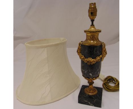A marble and gilt metal table lamp, oval with floral brass swags on raised square marble base to include shade, 40cm (h)