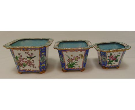 A set of three graduated oriental metal and enamel plant holders decorated with flowers and leaves, tallest 10cm (h)