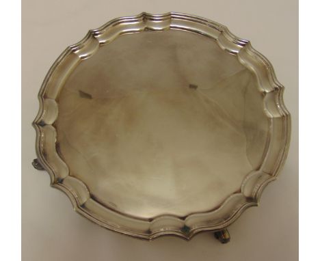 A hallmarked silver circular salver with Chippendale border on four volute scroll feet, Birmingham 1979 by A Chick &amp; Sons