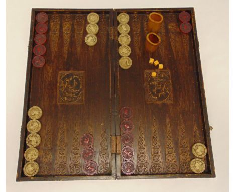 A Middle Eastern backgammon set in a carved wooden case